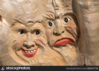 Wooden Tree Sculpture: Close-up of Faces Carved in Wood, Handmade.. Wooden Tree Sculpture: Close-up of Faces Carved in Wood, Handmade