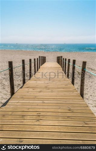 Wooden walkway over the sand dunes to the beach. Beach pathway in Praia de Paramos, Espinho, Portugal