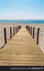 Wooden walkway over the sand dunes to the beach. Beach pathway in Praia de Paramos, Espinho, Portugal