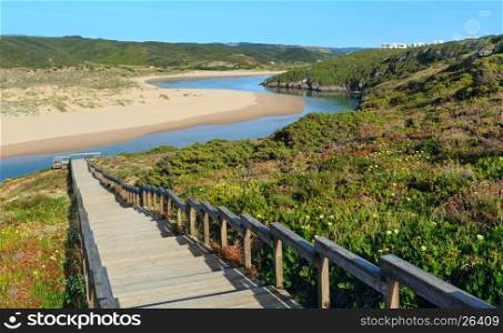Wooden walkway to Amoreira beach and Aljezur river summer view, Algarve region, Portugal.