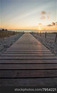 wooden walkway to Dutch beach at sunset