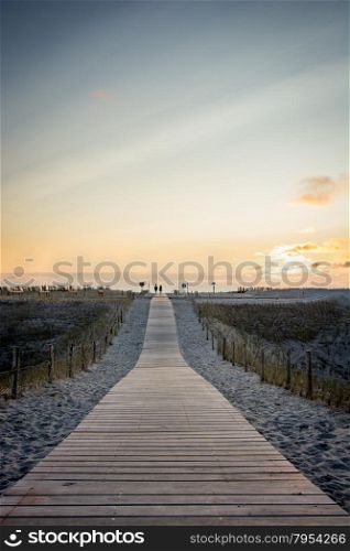 wooden walkway to Dutch beach at sunset