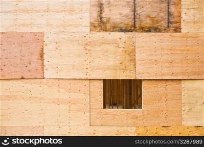 Wooden wall with window opening boarded up