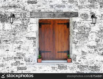 Wooden window in the stone wall of the house