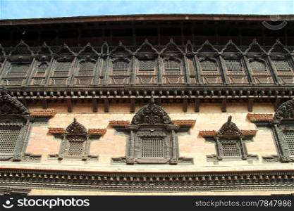 Wooden windows amd brick wall of palace in Bhaktapur, Nepal