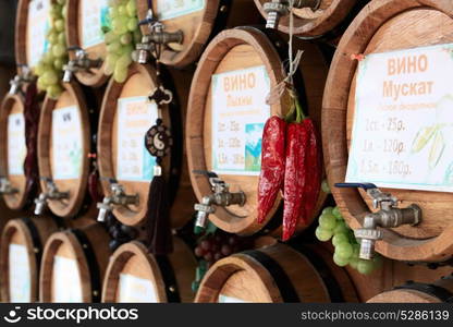 Wooden wine barrels, grapes and red hot chili peppers on the market