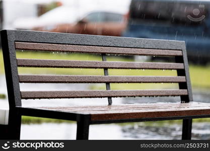 wooden with metal bench under the rain outdoors. High quality photo.. wooden with metal bench under the rain outdoors. High quality photo