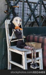 Wooden Worn-out Woman Marionette on White Chair