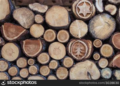 Woodpile with Beautiful Wood Decorations: Cross Section of Tree Trunks Background. Woodpile with Beautiful Wood Decorations: Cross Section of Tree Trunks Background.. Woodpile with Beautiful Wood Decorations: Cross Section of Tree Trunks Background