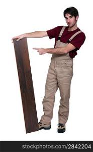 Woodworker standing with laminate flooring
