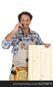 Woodworker standing with mobile phone