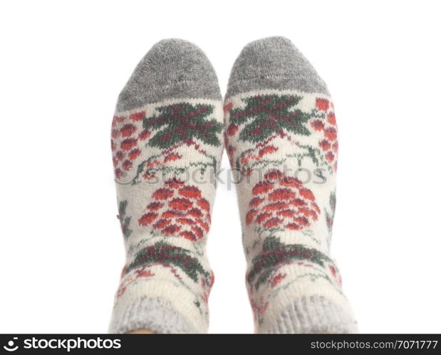 Wool socks on woman&rsquo;s feet isolated on a white background. Wool socks on woman&rsquo;s feet isolated on white background