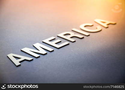 Word America written with white solid letters on a board. Word America written with white solid letters