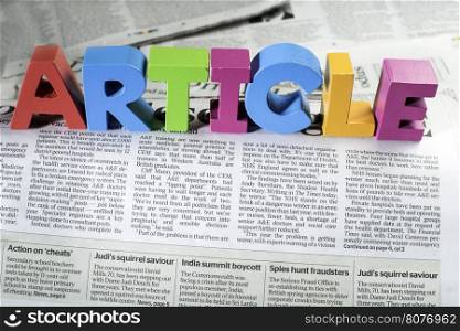 Word article on newspaper. Wooden letters