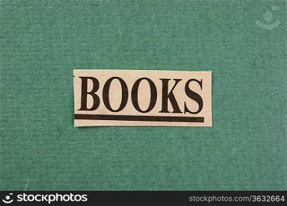 word books cut from newspaper on green background