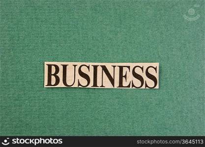word business cut from newspaper on green background