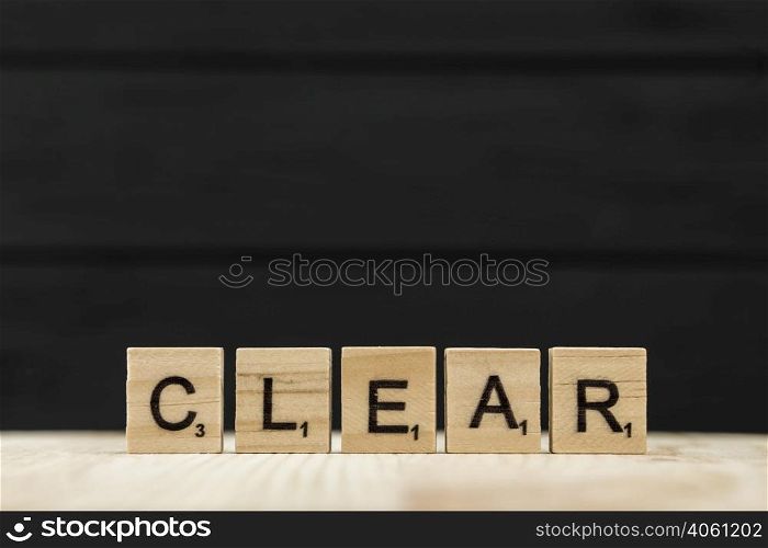 word clear spelt with wooden letters