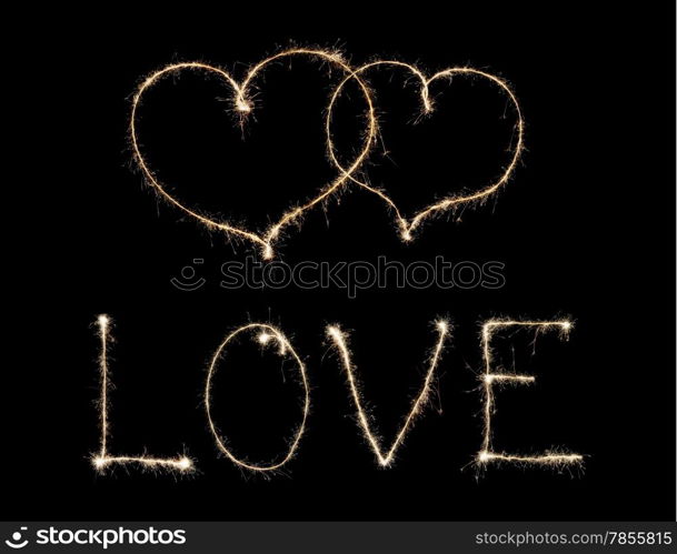 word love and two hearts from sparkler isolated on black background