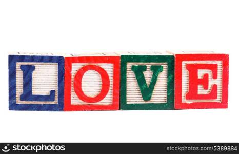 "Word "love" made from alphabet blocks on white"
