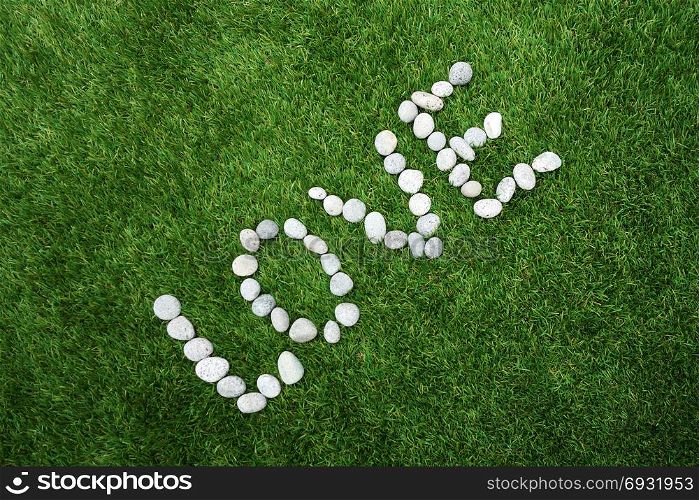 Word love made of pebble stones on green grass