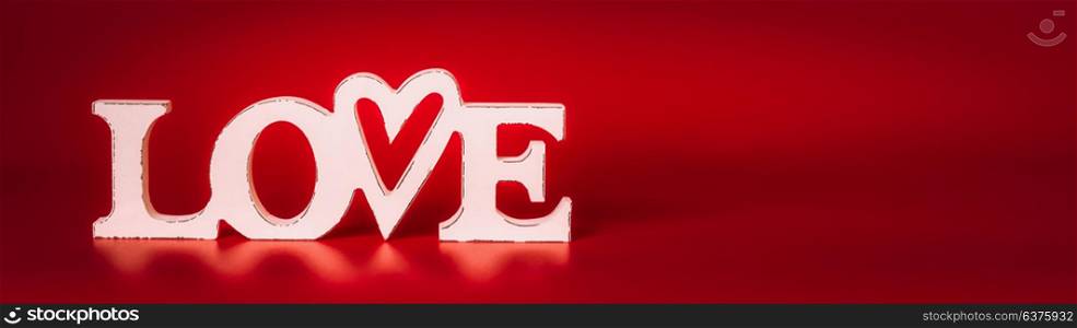Word Love sign on red background, front view. Valentines day concept, banner
