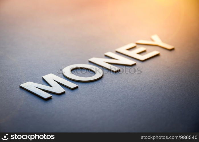 Word money written with white solid letters on a board. Word money written with white solid letters