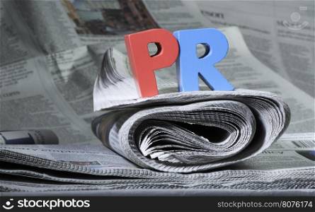 Word PR on newspaper. Wooden letters