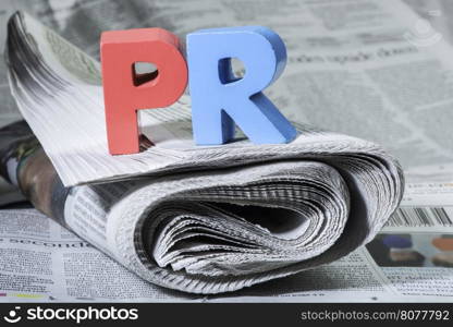 Word PR on newspaper. Wooden letters