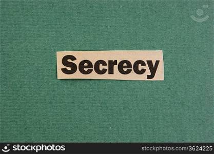 word secrecy cut from newspaper on green background