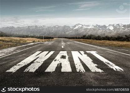 Word want on road. Natural landscape and asphalt road with drawn want road