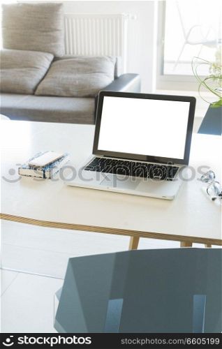 Work desk in apartment with laptop, copy space on blank screen. Work desk with laptop