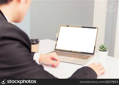 Work from home, Asian young businessman smile wearing suit video conference call or facetime by laptop computer sitting and listening to teammates explained on desk at home office