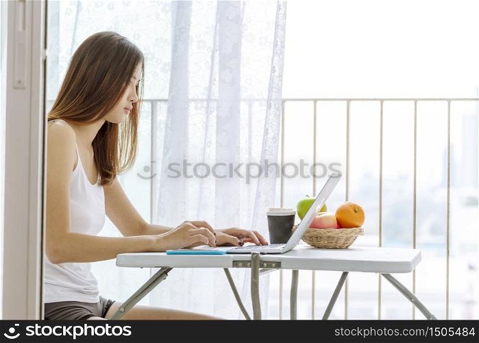 Work from home banner woman working on laptop outdoor at home cause of corona covid-19 virus world pandemic infection. Beautiful women connect internet outdoor working wireless internet technology