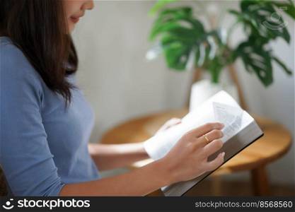 Work from home concept, Business women is reading a book to relax after working remotely at home.