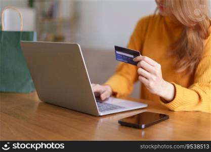 Work from home concept, Businesswoman is typing credit card data on laptop to shopping online.