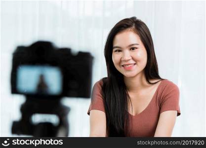 Work from home. Smiling Happy Asian young beautiful woman blogger with professional digital technology equipment live recording talking video call conferencing online videoblog channel