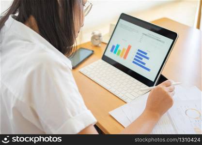 Work from home young Freelancer or Businessman working at home office with smartphone tablet. Working Online Or Studying And Learning While. Freelance Work, Business and Work from home concept