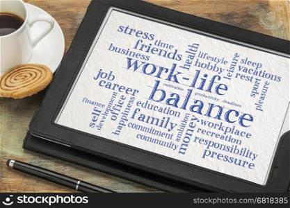 work life balance word cloud - word abstract on a digital tablet with a cup of coffee