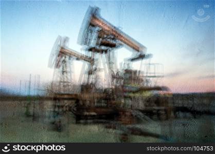 Work of oil pump jack on a oil field. Textured concrete grunge, blurred motion. Concept oil and gas industry.