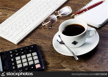Work place. Business work place with cup of coffee calculator and glasses