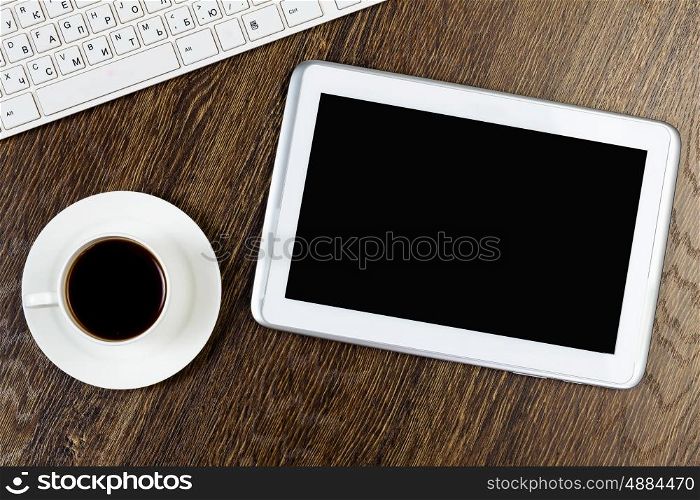 Work place. Tablet pc cup of coffee and keyboard at table