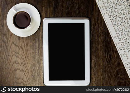 Work place. Tablet pc cup of coffee and keyboard at table