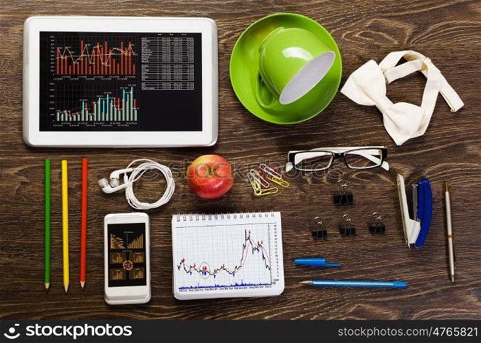 Work place. Tablet pc mobile phone and stationary items on wooden table
