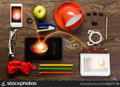 Work place. Tablet pc mobile phone and stationary items on wooden table