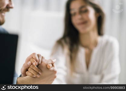 Work Relationship. Young Male and Female colleagues in Love at Work. Holding hands in the office.. Love Relationship at Work. Office Colleagues Having a Romantic Affair