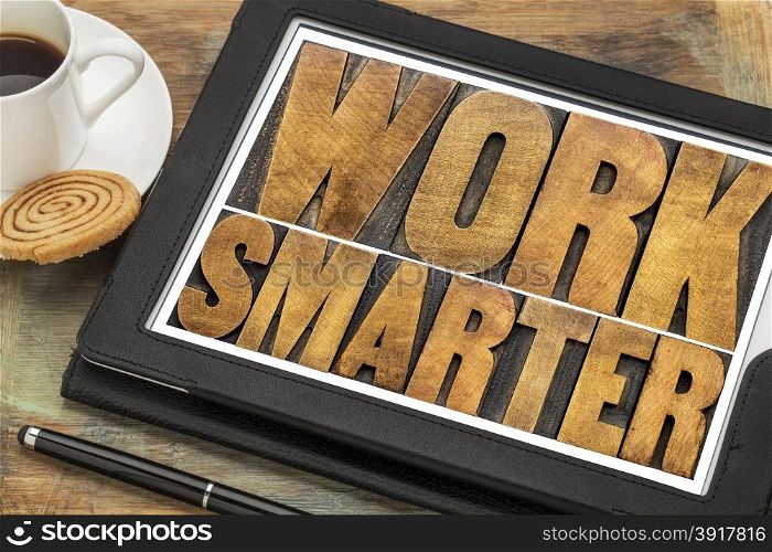 work smarter-advice wood type text on a digital tablet with a cup of coffee