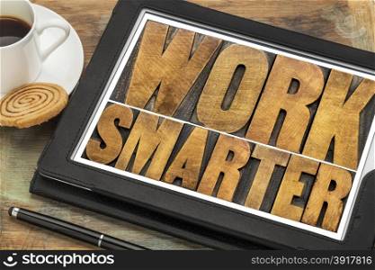 work smarter-advice wood type text on a digital tablet with a cup of coffee
