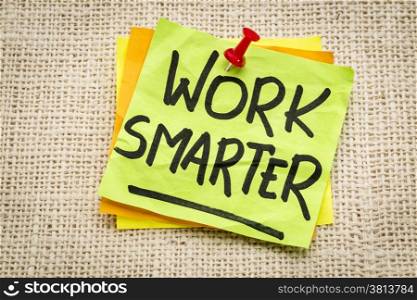 work smarter reminder on a green sticky note against burlap canvas
