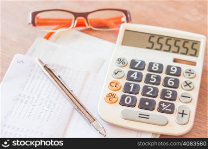 Work station with calculator, pen and eyeglasses, stock photo