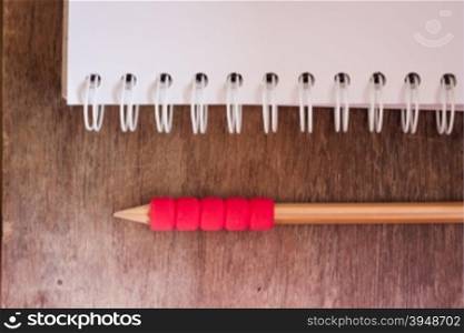 Work station with notebook and pencil with vintage filter, stock photo